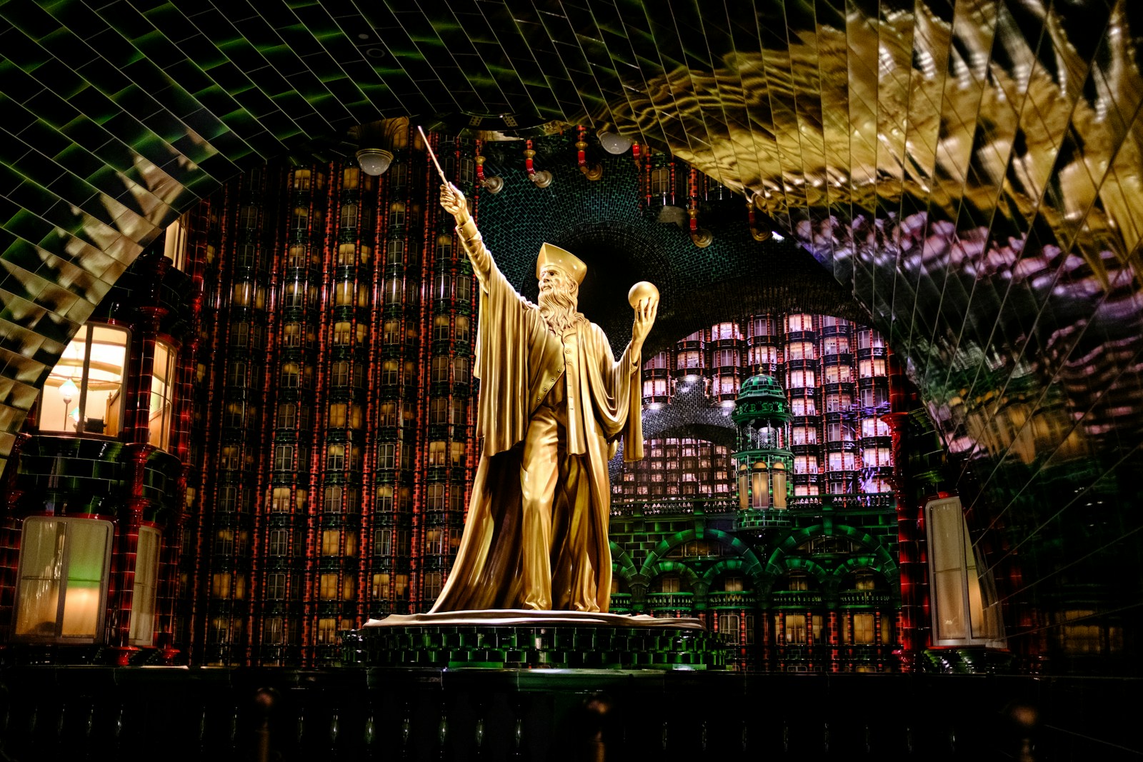A golden wizard statue in an enchanting hall.